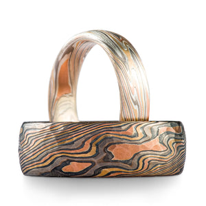 Mixed look mokume gane ring set, in multi metal combo, larger ring has an oxidized finish and hammered surface texture