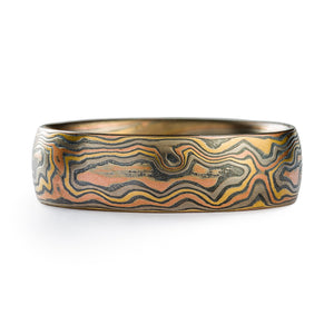 Mokume gane ring arn krebs, wedding band or ring, woodgrain pattern and firestorm palette, firestorm metal combination is red gold palladium silver and yellow gold, yellow gold is most prominent in this ring  Edit alt text