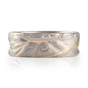 mokume gane pattern ring, topographical style patterning, mostly silver with a yellow gold stratum layer peeking out from under other layers
