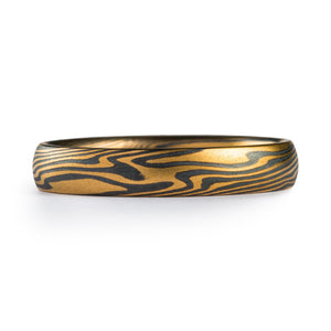 This bold but elegant Mokume Gane band is shown in the Twist pattern and the Spark metal combination with an etched and oxidized finish and a low dome profile.