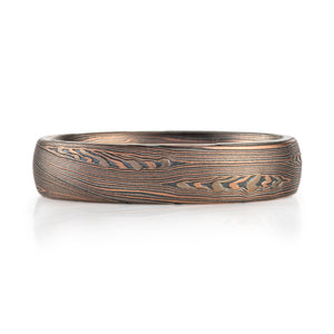 horizontal lines that flow around woodgrain knots very contemporary look in warm colors, reds, browns black, grey elegant ring bespoke 