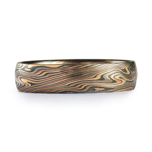 Firestorm Twist Kazaru Mokume Gane ring or wedding band by Arn Krebs, twist pattern and firestorm palette (red gold yellow gold palladium and silver), the ring also has our Kazaru surface treatment, the surface is gently and subtly carved into to create gentle texture that complements the twisting mokume pattern