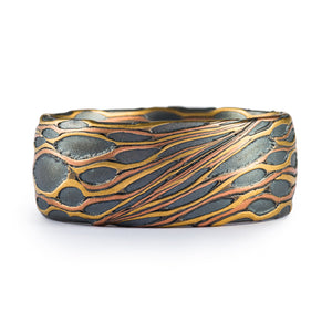 arn krebs custom made mokume gane ring, cholla cactus insipred ring with large patches of oxidized silver with strands of yellow and red gold