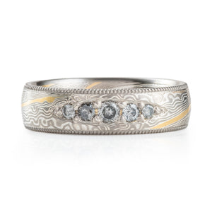 elegant wedding style band with bead set salt and pepper diamonds and milgrain rails on top and bottom edges and an added yellow gold stratum