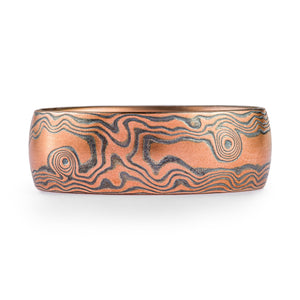 red gold mokume gane wedding ring, with oxidized silver in a woodgrain pattern, the color feels like the sands of a red desert