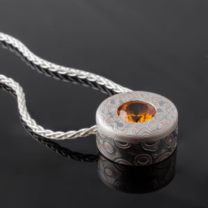 mokume necklace mokume gane orange stone Spessartite Garnet mixed metal nature inspired handcrafted contemporary modern earthy topographical multicolor metal palladium white gold oxidized sterling silver pattern