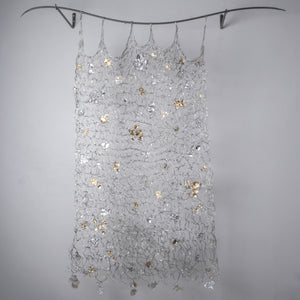 Long handmade wire tapestry, with gold silver and clear glass accent pieces sprinkled through out and hanging from the bottom edge. Tapestry hangs from a curved metal bar. Home decor, interior design, wall decoration