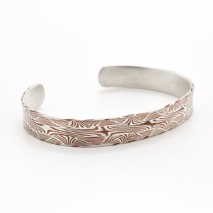 mokume gane bangle in intricate welded pattern made in copper and silver