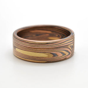 red and yellow gold mokume gane band in vortex pattern