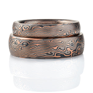 Set of dark palette mokume gane patterned rings, made in combination pattern with twisted and droplet style elements. Shown here in a combination of red gold, palladium and oxidized silver