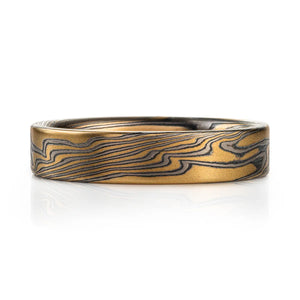 flat profile mokume gane band in custom billet, mostly yellow gold with thin layers of palladium and oxidized silver