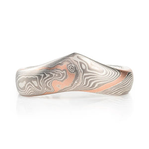 uniquely shaped pointed mokume gane ring tapered and with white and silver palette and added red gold stratum