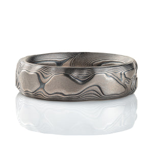 Gray and black mokume gane patterned ring, made to look like topographic/rock texture. 