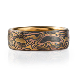 18kt yellow gold mokume gane ring in woodgrain pattern with domed profile, ring is made with golds and oxidized silver