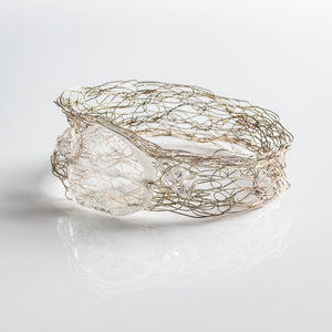 Wide silver wire spun bracelet, with large quartz piece and smaller pieces on either side.