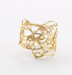 Ring made of yellow gold strands woven together in an organic style.