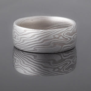 mokume gane shibuichi ring, made of light and dark gray metals in a twisting pattern