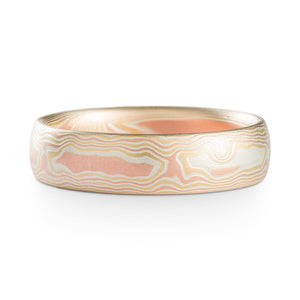 Mokume Gane ring or wedding band made by arn krebs, this ring is made in our woodgrain pattern and fire palette. The fire palette is red gold yellow gold and silver, and this ring has a non oxidized and etched finish with a low dome profile.