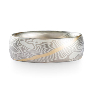 Mokume Gane Ring or wedding band, made by arn krebs, this ring is made in our twist pattern and ash palette, with a 14k yellow gold stratum added in and running through the center of the twist pattern diagonally through the ring, the ash palette is made up of palladium and sterling silver, this ring has a satin finish and low dome profile