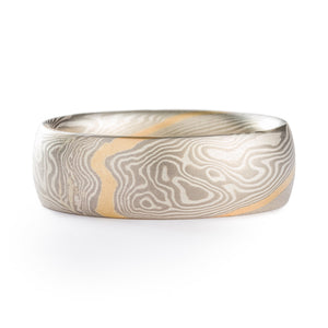 Mokume Gane style ring made by arn krebs, twist pattern with a gold strip running diagonally across the ring, the rest of the ring is alternating layers of silver and palladium 