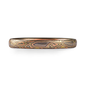 mokume gold ring with organic pattern of red gold yellow gold and silver