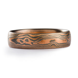 mokume gane band in flame palette (red gold and oxidized silver) in woodgrain pattern