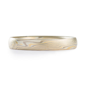 This gorgeous custom Mokume Gane ring features our Twist Pattern and is made in our Flare Palette with a flat profile and an etched finish. The Flare palette consists of 14kt Yellow Gold, Palladium, and Sterling Silver.