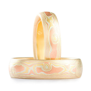 Matching ring set, mokume gane patterning resembling woodgrain, made with red gold yellow gold and non oxidized silver