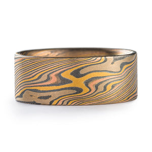 This bold Mokume Gane band is shown in the Twist Pattern and a custom version of our Firestorm Metal Combination, with an etched and oxidized finish and flat profile. This Firestorm palette features 14k Red Gold, 22k Yellow Gold, Palladium, and Sterling Silver.