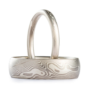 matching mokume gane ring set narrow and wide bands in a matching white and silver palette