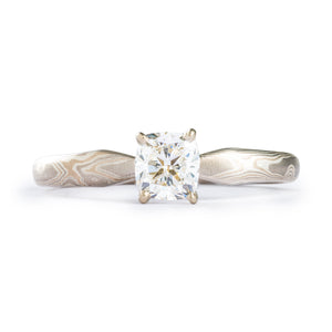 This gorgeous Mokume Gane ring is shown in the Woodgrain pattern and the Smoke metal combination. It also features a prong set square diamond, a low-dome profile, and lightly etched finish.