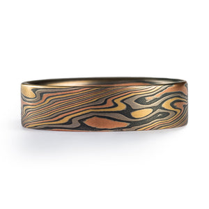 This rugged feeling Mokume Gane band is shown in the Twist pattern and the Firestorm metal combination, with a flat profile and an etched and oxidized finish.