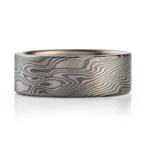 wide flat profiled ring, made in mokume twist pattern with alternating layers of palladium and oxidized silver