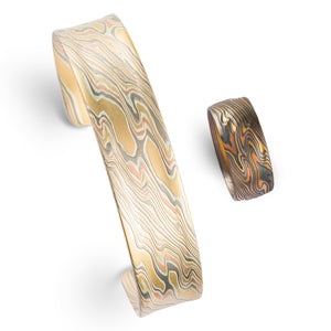 matching mens or gender neutral set of mokume bangle and wide ring in matching colors and twist pattern