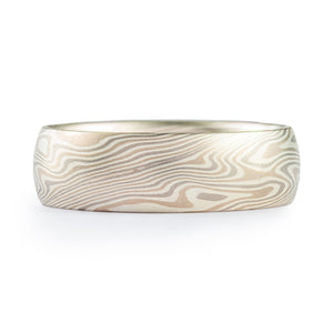 This cool and classic feeling Mokume Gane ring is shown in the Twist pattern and Smoke Palette, with a low dome profile, and a satin finish. The Smoke palette features a three metal combination of 14k White Gold, Palladium, and Sterling Silver.