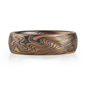 mokume gane wedding band with red gold yellow gold palladium and oxidized silver