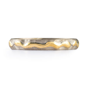 Patterned mokume gane style ring, the main ring is silver in color, and the center raised area is yellow gold, thin band, about a size 6 pictured here/