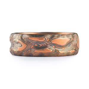 Mokume Gane ring with red gold rose gold and oxidized black silver metal in layered raised forms 