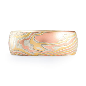 This lovely Mokume Gane band is shown in the Twist pattern and an 18kt version of our Fire metal combination with a heavily etched finish. This non oxidized version of the Fire palette brings to mind a gentle, quiet warmth. This Fire palette features 18k yellow gold, 18k red gold and sterling silver.