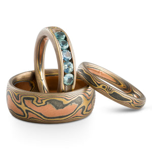 channel set sapphires ring set in mokume gane