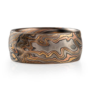 wide bold mokume gane band with carved texture details made with red gold yellow gold palladium and oxidized silver