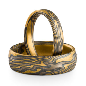 Mokume gane ring set in yellow gold palladium and oxidized silver combination in a twist pattern with texture