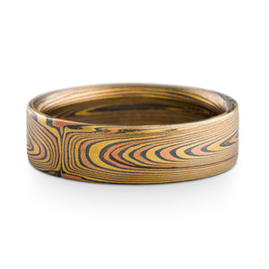 Mokume gane ring or wedding band arn krebs, vortex pattern, fire palette made up of red gold yellow gold and sterling silver, flat profile ring