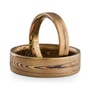 Arn Krebs Mokume Gane ring set, matching bands with flat profiles, vortex pattern, fire palette made up of yellow gold red gold and sterling silver  Edit alt text