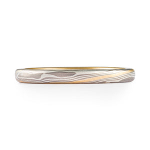 elegant mokume gane wedding ring, narrow style, yellow gold liner and stratum layer for accent
