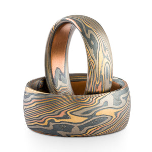 Mokume gane matching ring or wedding band set made by arn krebs, 6mm and 9mm widths, both rings made in firestorm palette and twist pattern, red gold yellow gold palladium and sterling silver