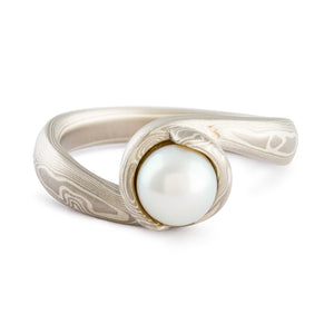 Mokume Gane ring wedding ring or engagement ring bypass style setting by arn krebs, woodgrain pattern and ash palette, white pearl, low dome, sterling silver and palladium