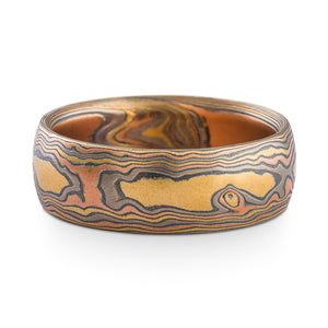 Mokume gane ring arn krebs, wedding band or ring, woodgrain pattern and firestorm palette, firestorm metal combination is red gold palladium silver and yellow gold, yellow gold is most prominent in this ring
