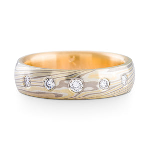Mokume Gane ring or wedding ring by arn krebs, flush set repurposed diamonds, twist pattern and flare palette, yellow gold silver and palladium