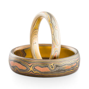 set of mokume gane woodgrain pattern rings with light and dark finishes